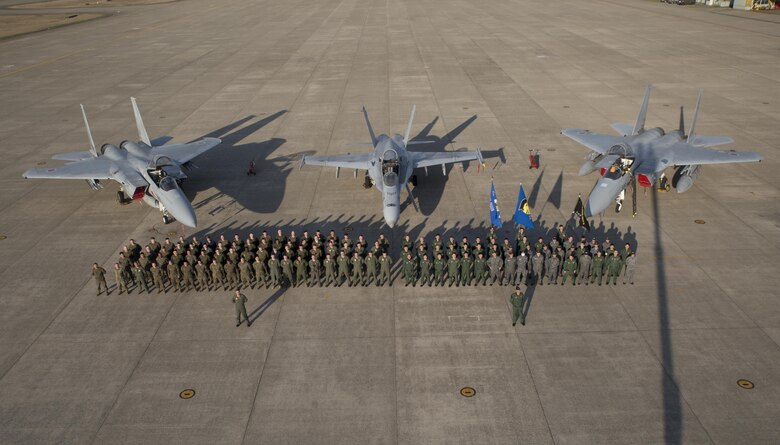 Members of Marine Fighter Attack Squadron (VMFA) 314 and Japan Air Self-Defense pose for a photo in front of an F/A-18AA++ and two F-15s at Komatsu Air Base, Japan, during the Komatsu Aviation Training Relocation exercise March 17, 2016. VMFA-314, home based out of Marine Corps Air Station Miramar, San Diego, temporarily deployed to MCAS Iwakuni for a six month rotation with the unit deployment program, is forward deployed to Komatsu, Japan for the ATR.  Komatsu ATR is a dissimilar air combat training exercise allowing pilots with diverse aircraft to simulate aerial warfare and execute basic fighter maneuvers, aircraft tactical intercepts and offensive-defensive counter air missions in preparation for real wartime situations. (U.S. Marine Corps photo by Cpl. Nicole Zurbrugg/Released)