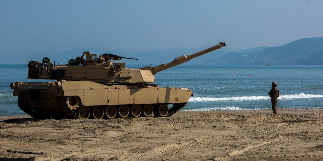 Cpl. Henry Estrada a gunner with 1st Tank Battalion from Lewisville, Texas, guides an M1A1 Abrams Main Battle Tank off the Landing Craft Air Cushion during rail operations at Dogu Beach, Republic of Korea, on March 15, 2016, as part of Exercise Ssang Yong 16. Ssang Yong 16 is a biennial combined amphibious exercise conducted by forward-deployed U.S. forces with the Republic of Korea Navy and Marine Corps, Australian Army and Royal New Zealand Army Forces in order to strengthen our interoperability and working relationships across a wide range of military operations - from disaster relief to complex expeditionary operations.