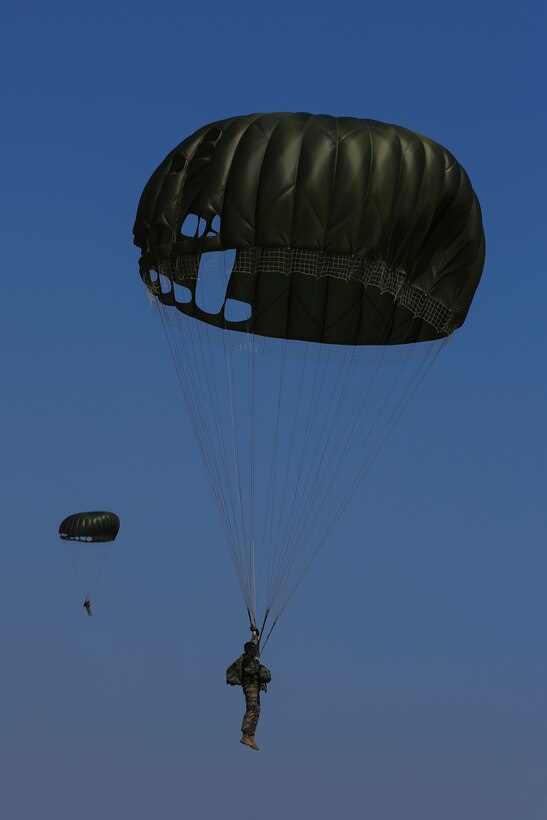 Paratroopers with the Republic of Korea Marine Corps land on a hill near Doksukri Beach, Republic of Korea, March 12, 2016, during a beach landing for exercise Ssang Yong 16. Ssang Yong is a biennial military exercise focused on strengthening the amphibious landing capabilities of the Republic of Korea, the U.S., New Zealand and Australia. (U.S. Marine Corps photo by MCIPAC Combat Camera Cpl. Allison Lotz/Released)