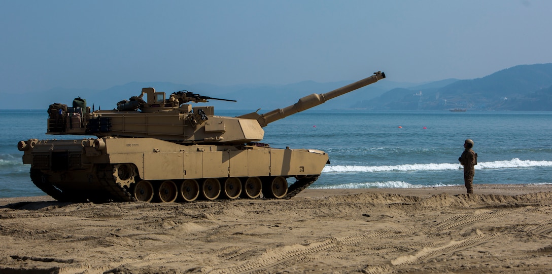 Cpl. Henry Estrada a gunner with 1st Tank Battalion, guides an M1A1 Abrams Main Battle Tank off the landing craft air cushion during rail operations at Dogu Beach, Republic of Korea, on March 15, 2016, as part of Exercise Ssang Yong 16. Ssang Yong 16 is a biennial combined amphibious exercise conducted by forward-deployed U.S. forces with the Republic of Korea Navy and Marine Corps, Australian Army and Royal New Zealand Army Forces in order to strengthen our interoperability and working relationships across a wide range of military operations.