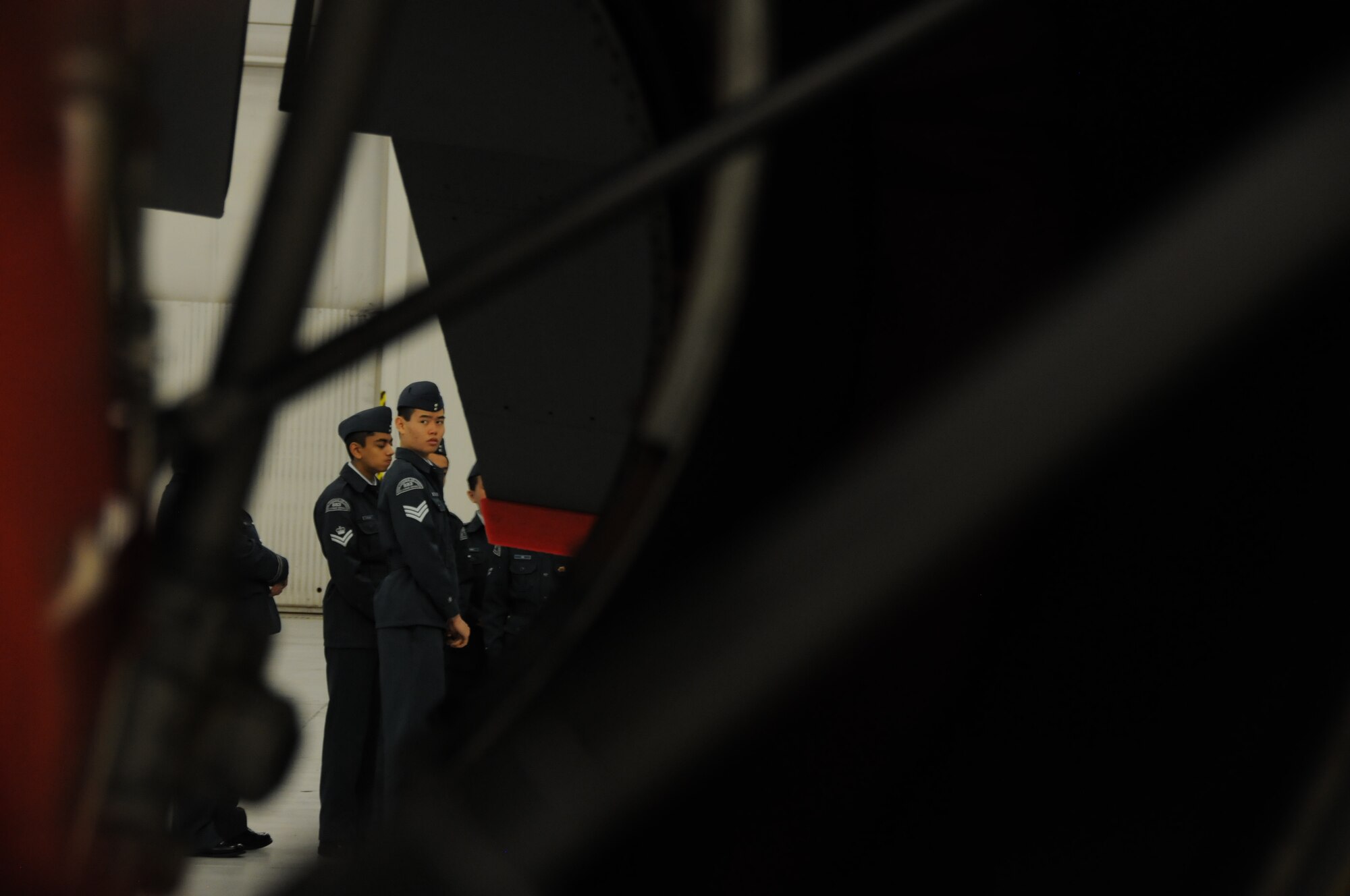A Royal Canadian Air Cadet is seen through the open engine of a 459th Air Refueling Wing KC-135R Stratotanker inside a hangar on the Joint Base Andrews, Md., flight line March 15, 2016. The tour group observed the inner workings of a KC-135R Stratotanker engine, boom arm and cargo area as well as discussed life as a U.S. Air Force Reserve member with citizen Airmen. (U.S. Air Force photo/Staff Sgt. Kat Justen)  