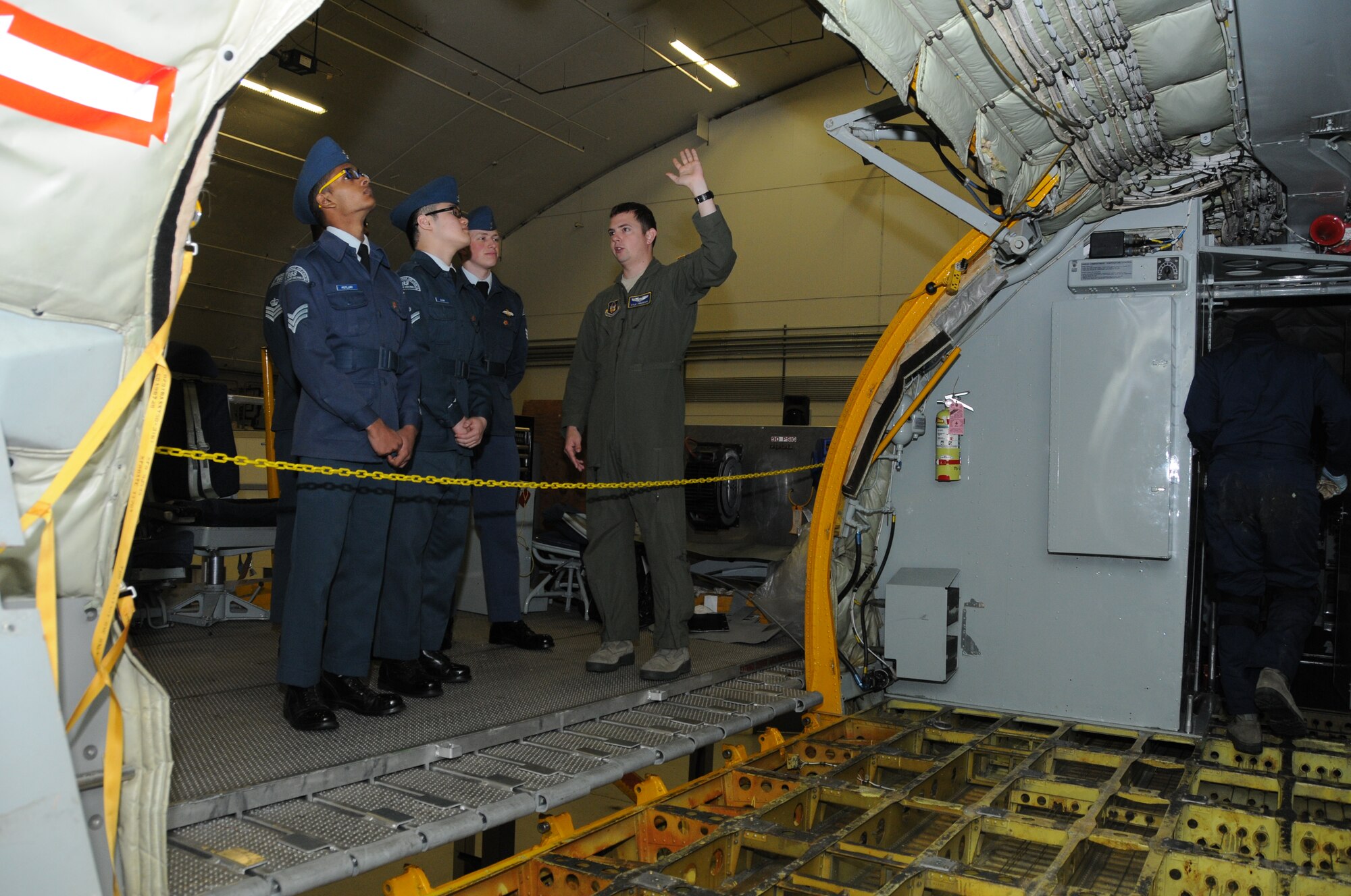 First Lt. Kyle Swenson, 756th Air Refueling Squadron pilot, showcases 459th Air Refueling Wing missions to a squadron of Royal Canadian Air Cadets inside a hangar on the Joint Base Andrews, Md., flight line March 15, 2016. The tour group observed the inner workings of a KC-135R Stratotanker engine, boom arm and cargo area as well as discussed life as a U.S. Air Force Reserve member with citizen Airmen. (U.S. Air Force photo/Staff Sgt. Kat Justen)  