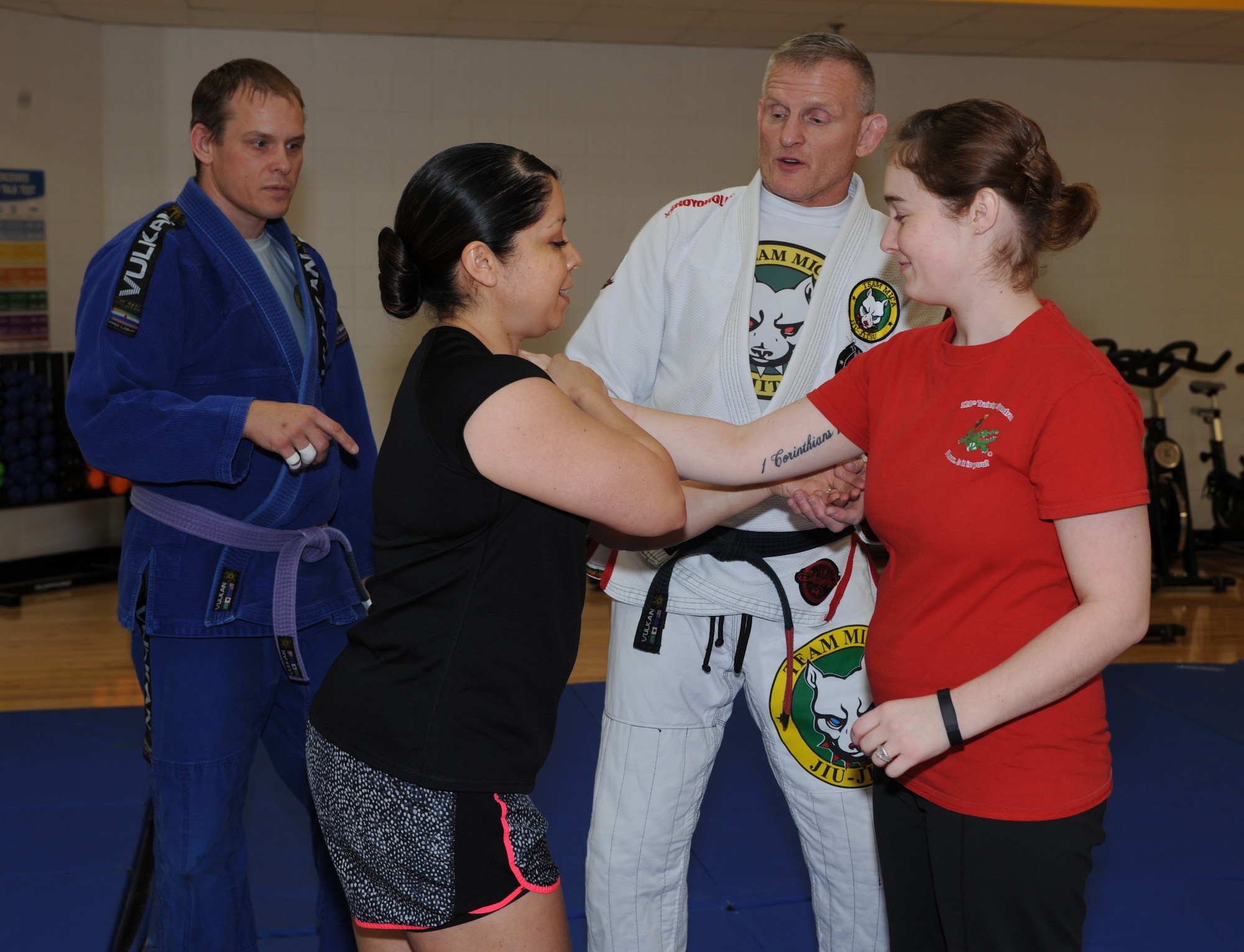 U.S. Army National Guard Sgt. 1st Class Michael Huitema, 109th Regional Support Group detachment sergeant, center, watches U.S. Air Force Master Sgt. Erlinda Schommer, 28th Medical Support Squadron superintendent, left, perform a technique during a women’s self-defense training seminar at Ellsworth Air Force Base, S.D., March 14, 2016. Huitema taught many techniques during the seminar, including escaping chokeholds and how to react in an active shooter situation. (U.S. Air Force photo by Airman 1st Class Denise M. Nevins/Released)