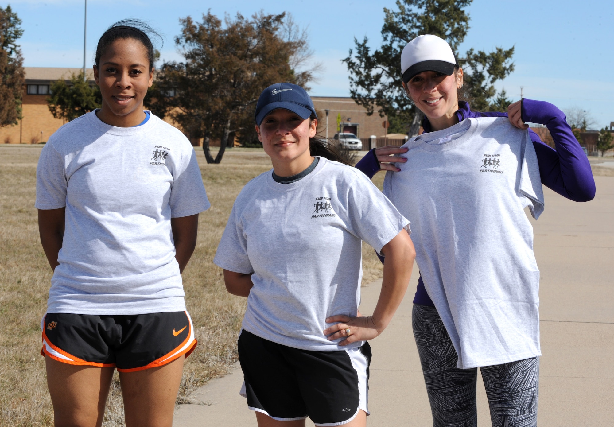Airman 1st Class Sadie Colbert, 28th Bomb Wing Public Affairs photojournalist, left, Master Sgt. Liriano Alvarado, 28th Civil Engineer Squadron customer service NCO in charge, middle, and Carmen Rodriguez, 28th Force Support Squadron Bellamy Fitness Center customer service representative, right, pose for a photo as the top three females in the Rucksack March 10K at Ellsworth Air Force Base, S.D., March 11, 2016. Approximately 10 people volunteered for the event as water station monitors or road guards, helping to ensure a safe and successful event for all participants. (U.S. Air Force photo by Airman 1st Class Denise M. Nevins/Released)