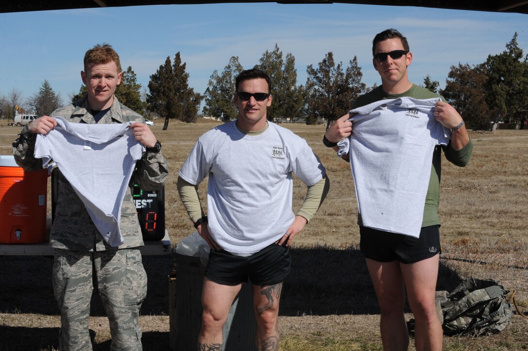 Senior Airman Tyler Wright,28th Security Forces Squadron armorer, left, Master Sgt. Layne Mayerstein, 28th Civil Engineer Squadron explosive ordinance disposal technician, middle, and Staff Sgt. Scott Greco, 28th CES EOD technician, right, pose for a photo as the top three males in the Rucksack March 10K at Ellsworth Air Force Base, S.D., March 11, 2016. More than 80 Airmen and civilians participated in the event. (U.S. Air Force photo by Airman 1st Class Denise M. Nevins/Released)