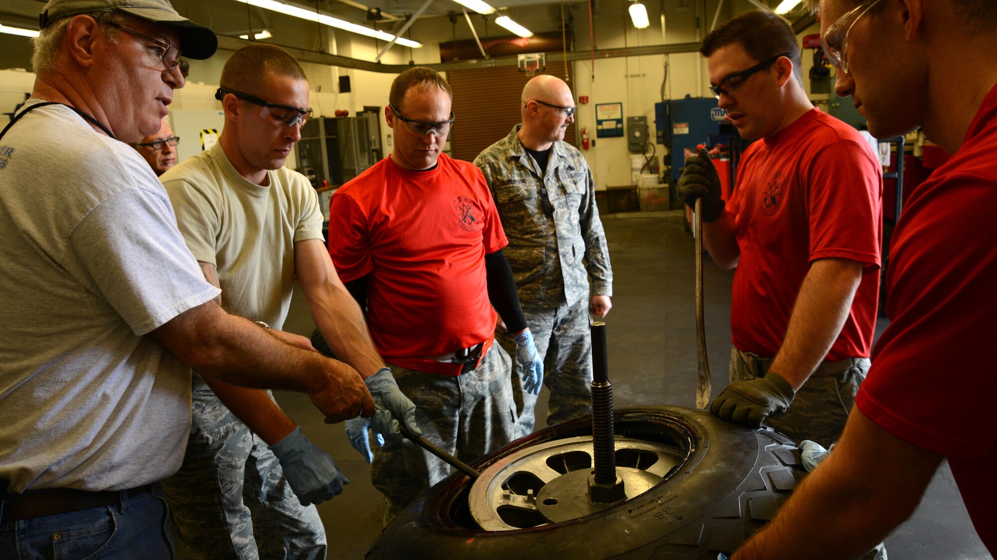 A 22nd Maintenance Squadron wheel and tire section Airmen and ‘Doc and Friends’ plan on how to set a tire on a B-29 Stratofortress wheel, March 11, 2016, at McConnell Air Force Base, Kan.  The restoration will make it the second flying B-29 in the world. (U.S. Air Force photo/Airman 1st Class Christopher Thornbury)