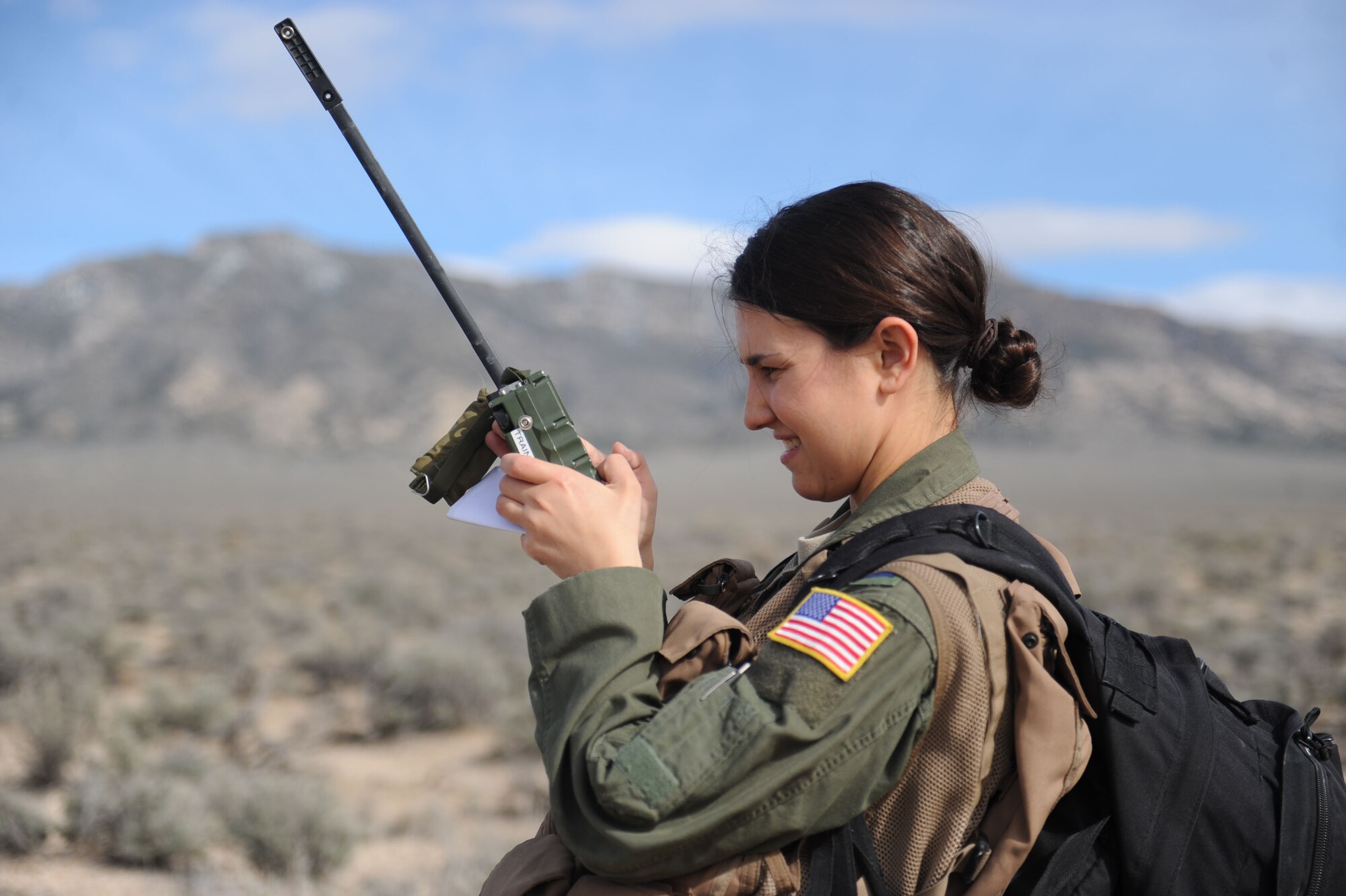 First Lt. Adria Trgovcich, 350th Air Refueling Squadron navigator, uses a Combat Survivor Evader Locator device, March 9, 2016, in a mountain range near Rachel, Nev. She was a simulated downed pilot during Red Flag 16-2. (U.S. Air Force photo/Senior Airman David Bernal Del Agua)