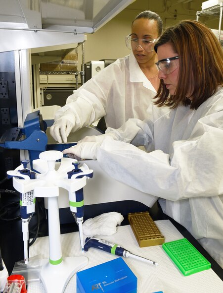 DoD DNA Registry, Armed Forces DNA Identification Laboratory (AFDIL) Research DNA Analyst, Jennifer Higginbotham, and Supervisory DNA Analyst, Kerriann Meyers, work on the hybridization capture portion of the Next Generation DNA Sequencing (NGS) protocol. AFDIL, which is part of the Armed Forces Medical Examiner System (AFMES) at Dover AFB, Del., is working with the newest innovation in Forensic DNA science, Mitochondrial DNA (mtDNA) Hybridization Capture and Next Generation DNA Sequencing (NGS). (U.S. Navy photo by Mass Communication Specialist 2nd Class Samantha Thorpe)