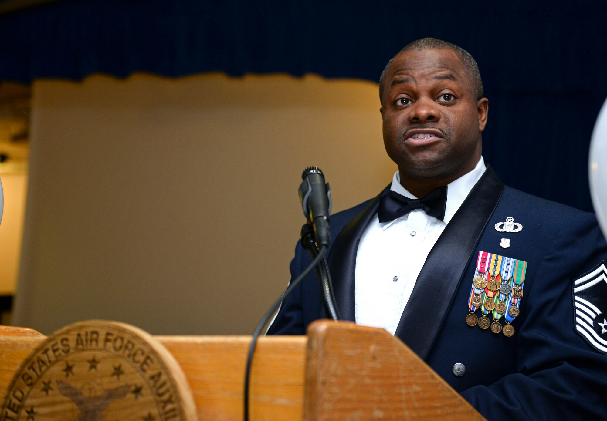U.S. Air Force Senior Master Sgt. Cornelious Thompson, 100th Operations Support Squadron superintendent and Civil Air Patrol senior member, welcomes guests to the CAP dining out March 12, 2016, at the Liberty Club on RAF Lakenheath, England. The Mildenhall Cadet Squadron celebrated its first year with a dining out since the unit’s activation March 2, 2015. (U.S. Air Force photo by Staff Sgt. Micaiah Anthony/Released)