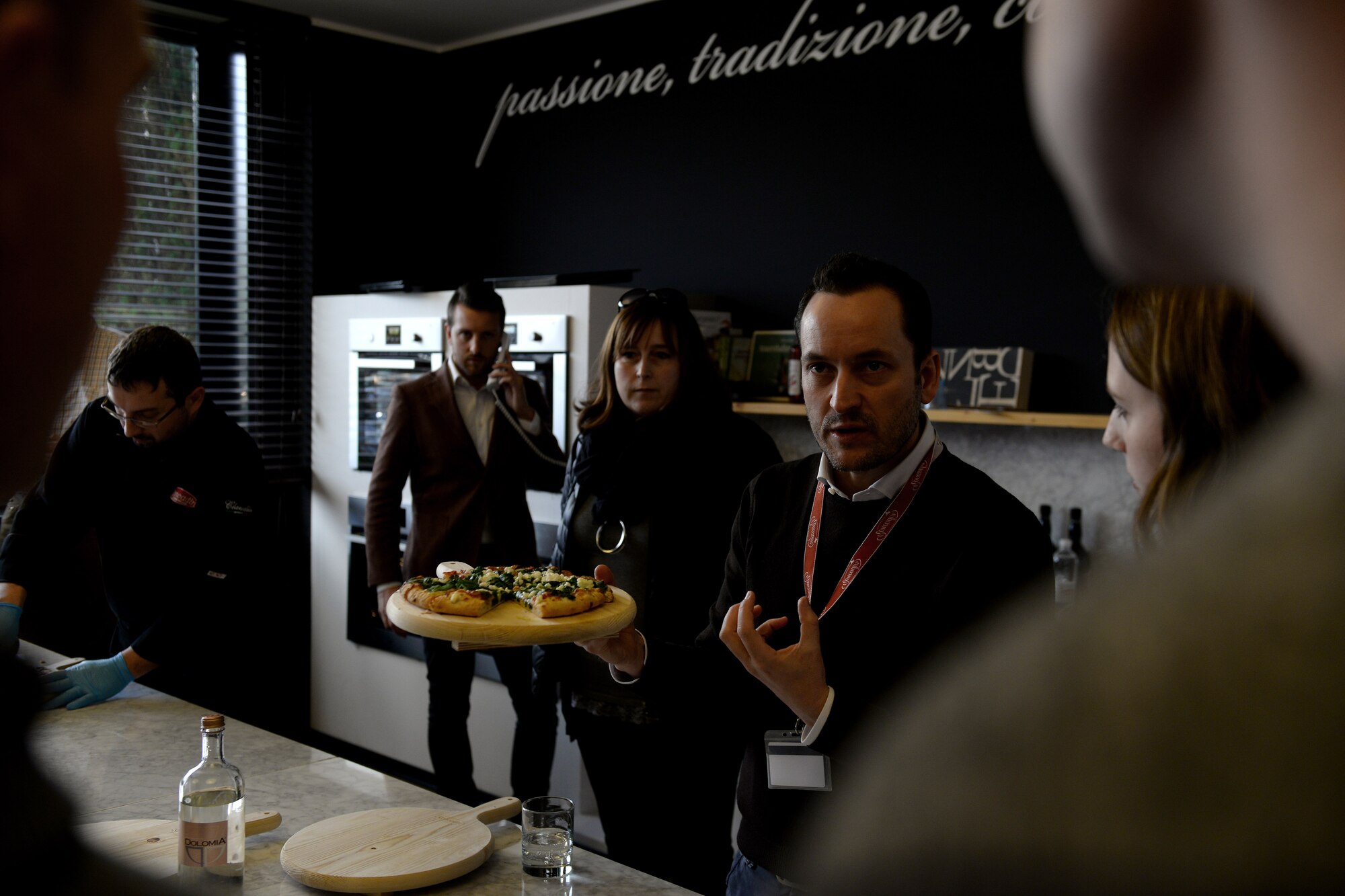 Dario Roncadin explains production processes during a local pizza factory visit, March 14, 2016, in Meduno, Italy. Officers from the 31st Logistics Readiness Squadron visited a local business to understand how it overcame obstacles to be successful. (U.S. Air Force photo by Airman 1st Class Cary Smith/Released) 