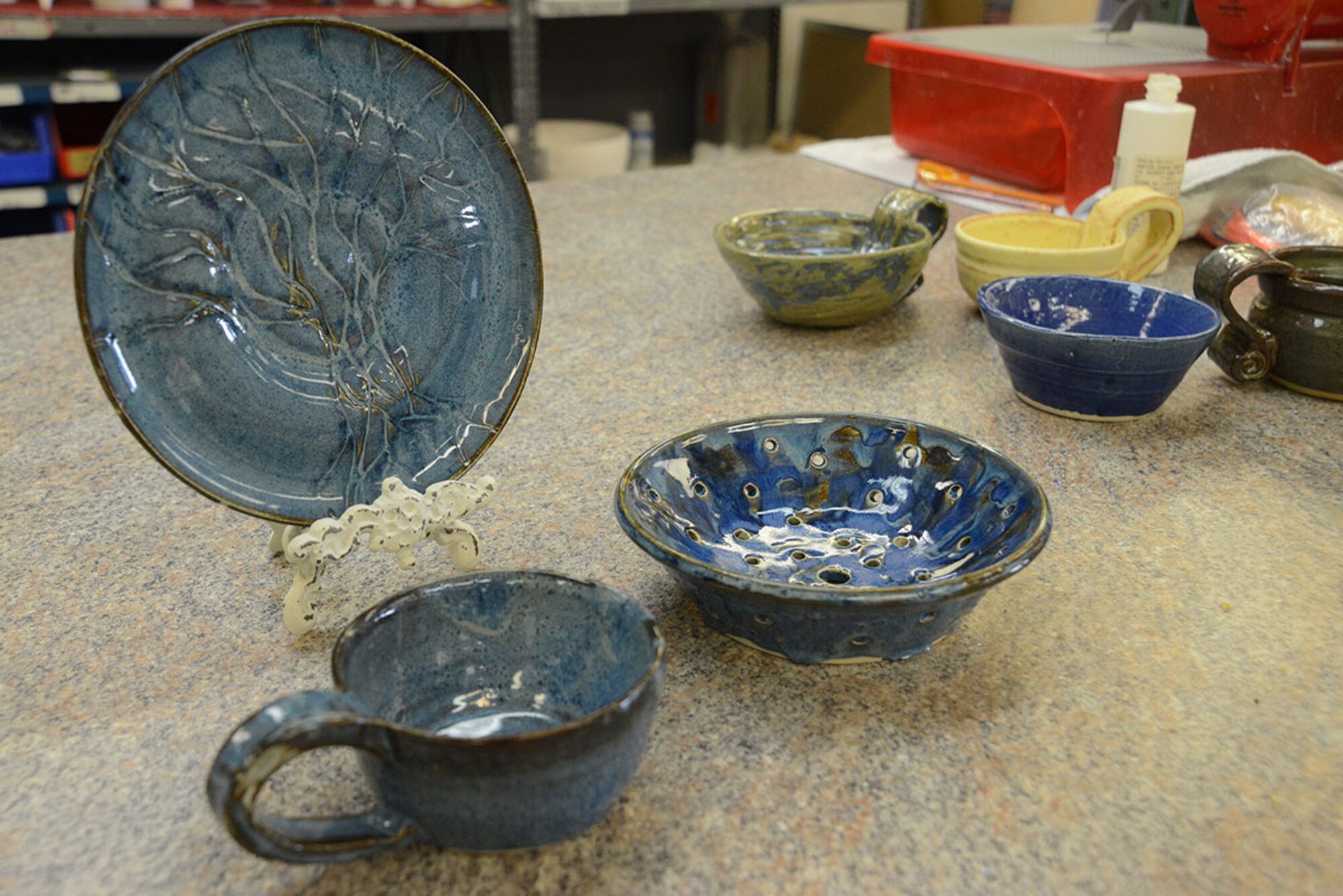 Bowls, plates and mugs created U.S. Coast Guard spouse Laura Fox sits on display at the Polar Express Arts and Crafts Center at Joint Base Elmendorf-Richardson, Alaska, Feb. 28, 2016. Fox began creating pottery four years ago, but moved to Alaska seven months ago with her spouse Senior Chief Petty Officer Alan Fox, United States Coast Guard Sector Anchorage command center supervisor. Fox glazed her latest creations in teal and plans to continue until she finds a more appealing color. (U.S. Air Force photo by Airman 1st Class Christopher R. Morales)