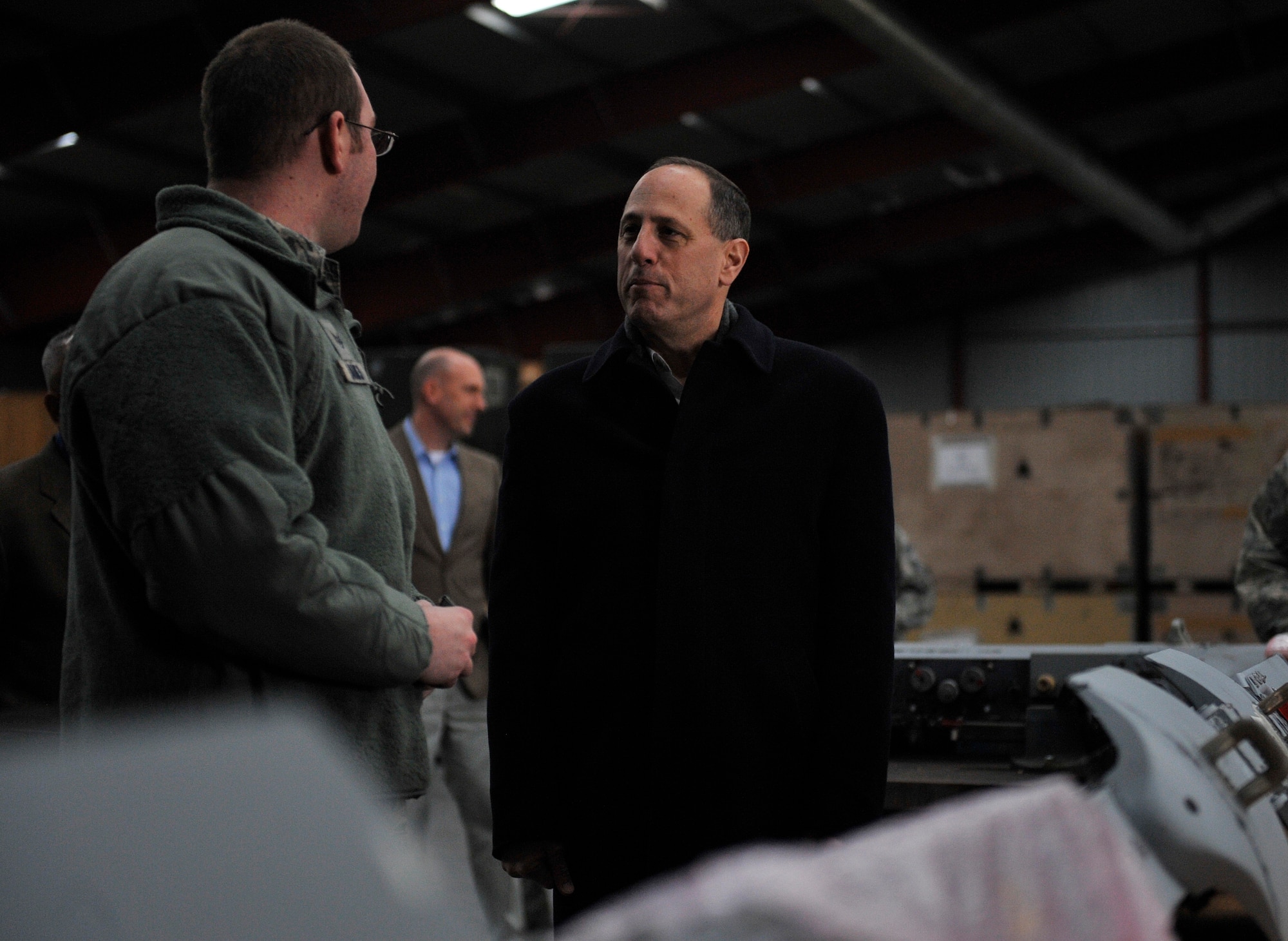 Staff Sgt. Travis Banks, 86th Materiel Maintainance Squadron armament systems technician, talks to Lt. Gen. Lee K. Levy II, Air Force Sustainment Center commander, about the capabilities the Central Regional Storage Facility site offers March 3, 2016, at Sanem, Luxembourg. The 86th MMS has the capability to store and maintain 500,000 square feet of equipment to be deployed at any given moment. (U.S. Air Force photo/Airman 1st Class Larissa Greatwood) 