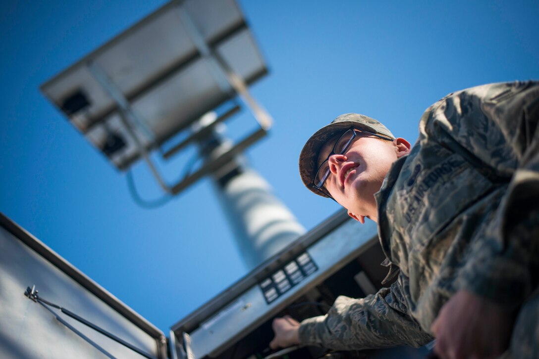 Airman 1st Class Jason Geiger, 744th Communications Squadron radio frequency transmissions technician, inspects the base notification system giant voice at Joint Base Andrews, Md., March 17, 2016. RF transmission technicians conduct routine inspections to ensure equipment is properly maintained. (U.S. Air Force by Staff Sgt. Chad C. Strohmeyer/Released)