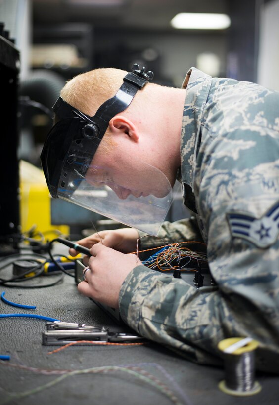 Senior Airman Michael Murphy, 744th Communications Squadron radio frequency transmissions technician, solders wires on a test panel box at Joint Base Andrews, Md., March 17, 2016. RF transmission technicians deploy, sustain, troubleshoot and repair the vast variety of communications devices to include antenna systems, tuners and transmission lines. (U.S. Air Force by Staff Sgt. Chad C. Strohmeyer/Released)