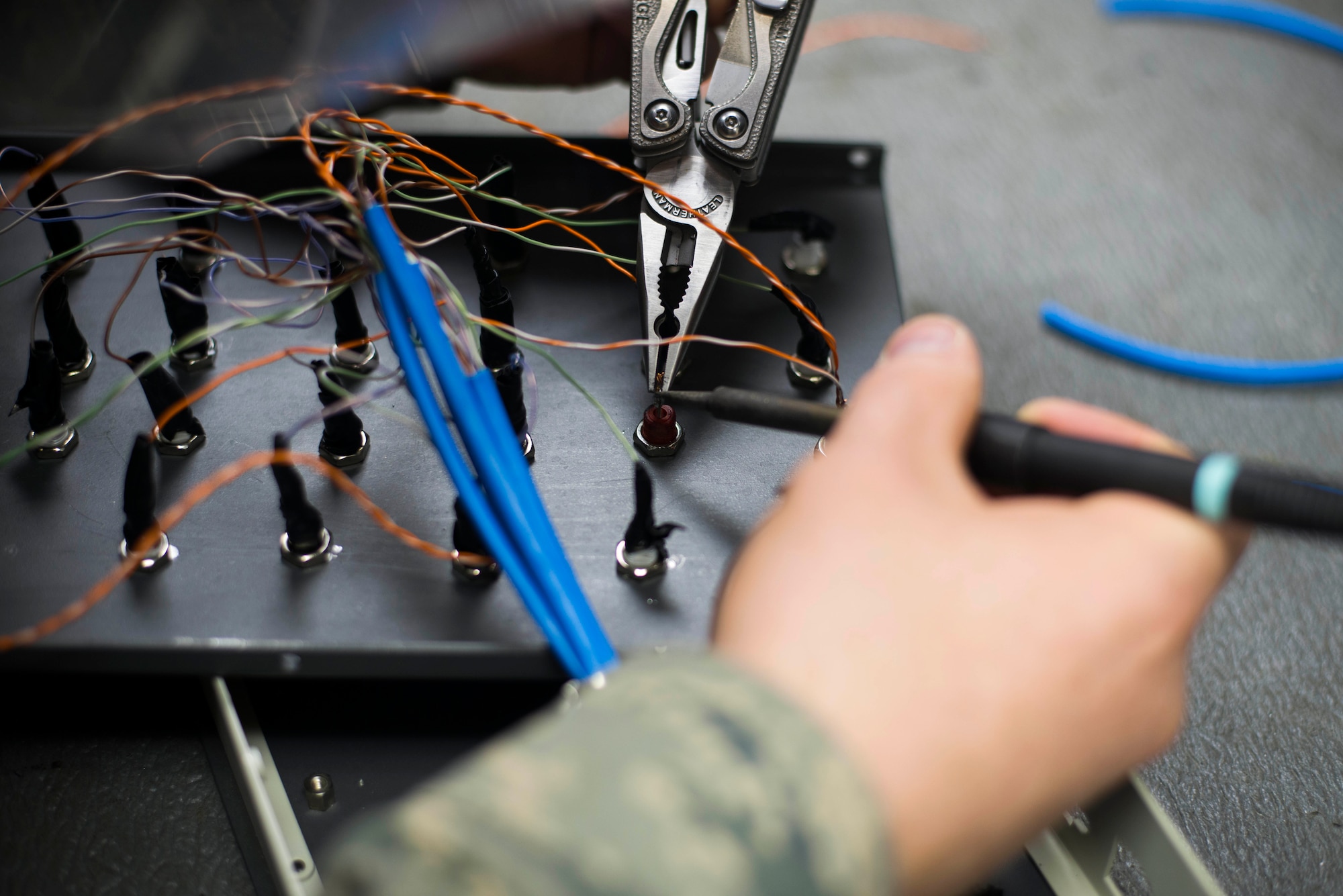 Senior Airman Michael Murphy, 744th Communications Squadron radio frequency transmissions technician, solders wires on a test panel box at Joint Base Andrews, Md., March 17, 2016. RF transmission technicians deploy, sustain, troubleshoot and repair the vast variety of communications devices to include antenna systems, tuners and transmission lines. (U.S. Air Force by Staff Sgt. Chad C. Strohmeyer/Released)