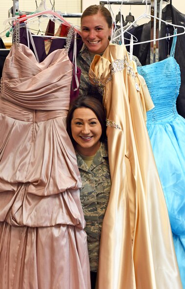 Staff Sgt. Sheena Young, 341st Missile Wing command chief executive, top, and Tech. Sgt. Jenny Johnson-Newman, 341st Medical Operations Squadron NCO in charge of health management, pose for a photograph at the Cinderella’s Closet shop March 15, 2016 at Malmstrom Air Force Base, Mont. The shop offers youth, teen and women’s dresses for every occasion from formal settings to proms, weddings and receptions. (U.S. Air Force photo/Airman Collin Schmidt) 