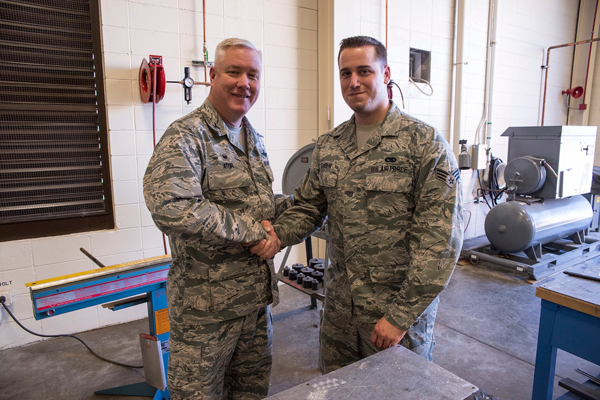 Col. Robert Ator II, commander of the 189th Airlift Wing, coining Senior
Airman Joshua Chaplin, 189th Maintenance Group's fabrication shop as Combat
Airlifter of the Week Mar. 15, 2016, at LIttle Rock Air Force Base, Ark. Chaplin, a part time police officer for the Austin Police Department, was able to save a man from a burning vehicle.  (Air National Guard photo by Master Sgt. Chris A. Durney) 
