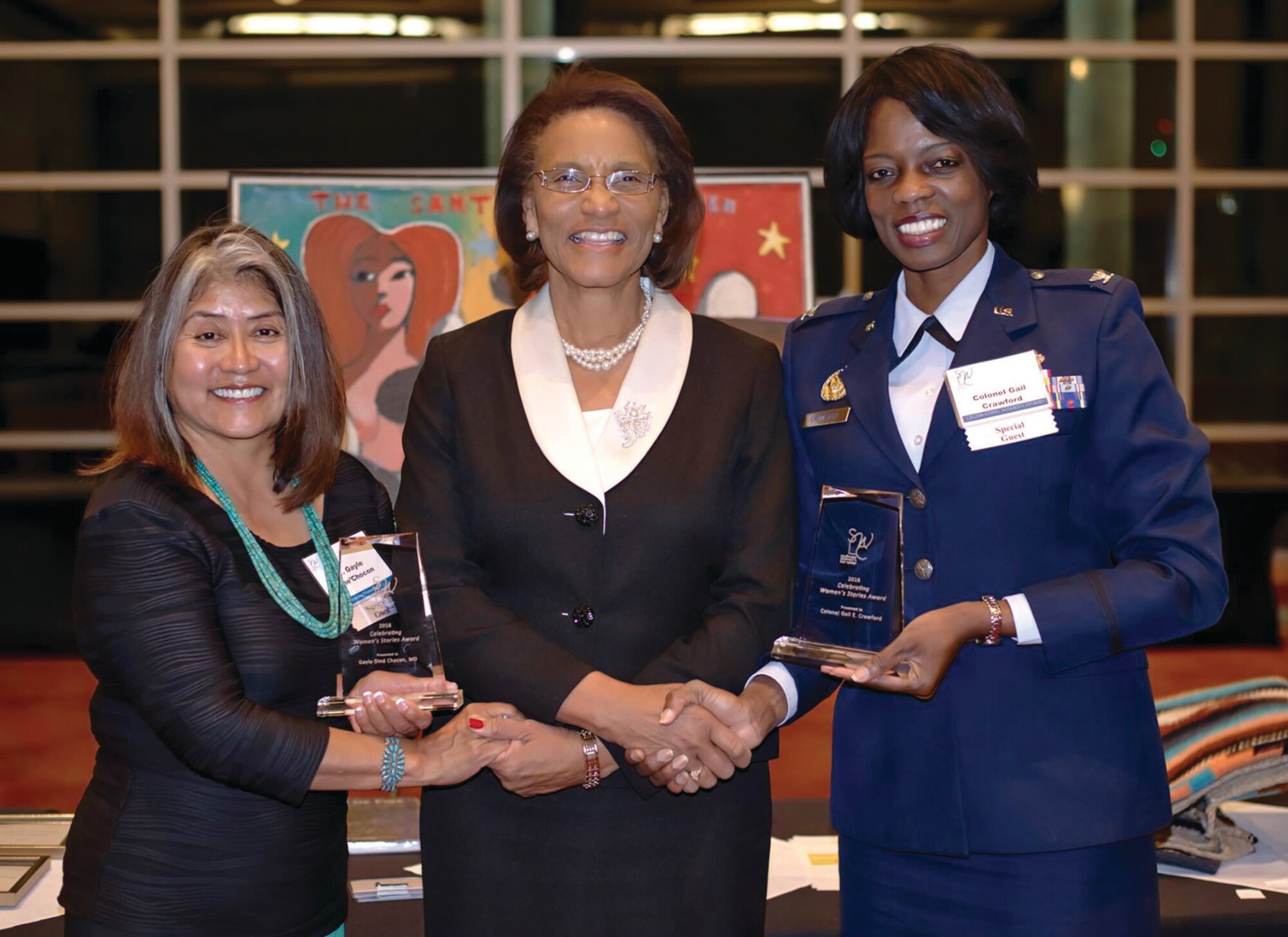 Col. Gail Crawford, right, senior legal adviser to the Air Force Nuclear Weapons Center commander, was honored by the Southwest Women’s Law Center at its Celebrating Women’s Stories awards banquet March 12 at the University of New Mexico Student Union Ballroom. Crawford is currently the highest-ranking active-duty African-American female member of the Judge Advocate General Corps, and one of four African-American females in Air Force history to become an active-duty colonel in the JAG Corps. Also getting recognized was Gayle Dine’Chacon, left, the first female surgeon general of the Navajo Nation. The award recipients flank Pamelya Herndon, executive director of the Southwest Women's Law Center in Albuquerque. (Courtesy photo)