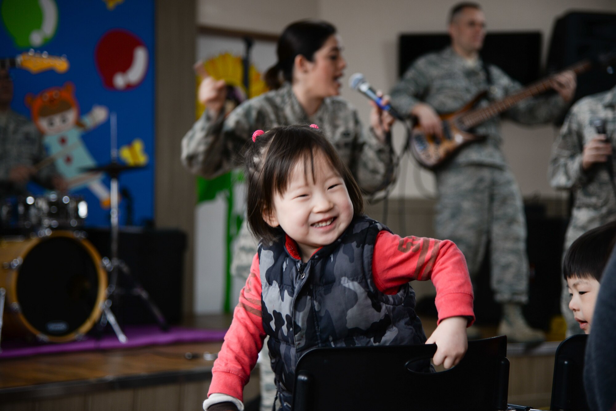 A Korean child sings during a concert with the U.S. Air Force Band of the Pacific-Asia ensemble Pacific Trends March 13, 2016, in Pyeongtaek, Republic of Korea. The PACAF Band consists of full-time active duty musicians performing in the Western Pacific region in support of military and community relations objectives. (U.S. Air Force photo by Airman 1st Class Dillian Bamman/Released)