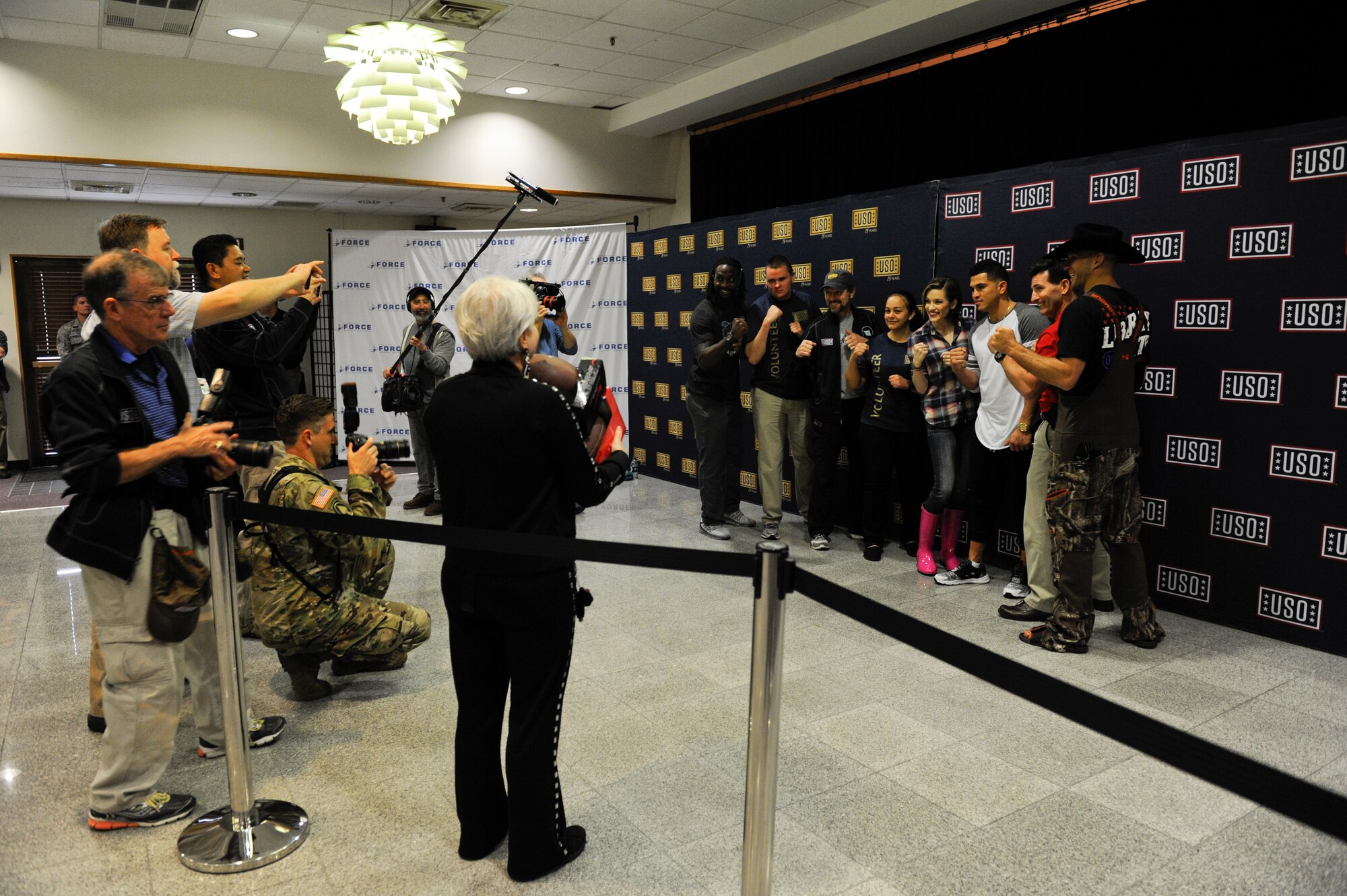 Team Kadena members and celebrity guests take group photos during the the United Service Organization Spring Visit tour, March 14, 2016, at Kadena Air Base, Japan. The USO organized the tour, featuring celebrities Miss America Betty Cantrell, Ultimate Fighting Championship athletes Donald Cerrone and Anthony Pettis, country music artist Craig Morgan, and Carolina Panthers cornerback Charles Tillman. (U.S. Air Force photo by Senior Airman Peter Reft)