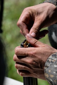 A Guatemalan Marine loads a magazine with 5.56 caliber ammunition during a live-fire training exercise March 10, 2016, Guatemala. The Guatemalan marines completed a four-week course with U.S. Marine trainers to hone their skills in small team movements and countering drug traffickers in urban environments. (U.S. Air Force photo by Staff Sgt. Westin Warburton/RELEASED)