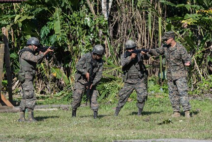 Subject matter experts from a U.S. Marine Security Cooperation Team provide proper firing and safety techniques March 10, 2016, Guatemala, during a live-fire exercise. The exercise was part of a final evaluation in a four-week course requested by the Guatemalans, providing training and real-life simulations to help the Guatemalans conduct counter-drug operations. (U.S. Air Force photo by Staff Sgt. Westin Warburton/NOT RELEASED)