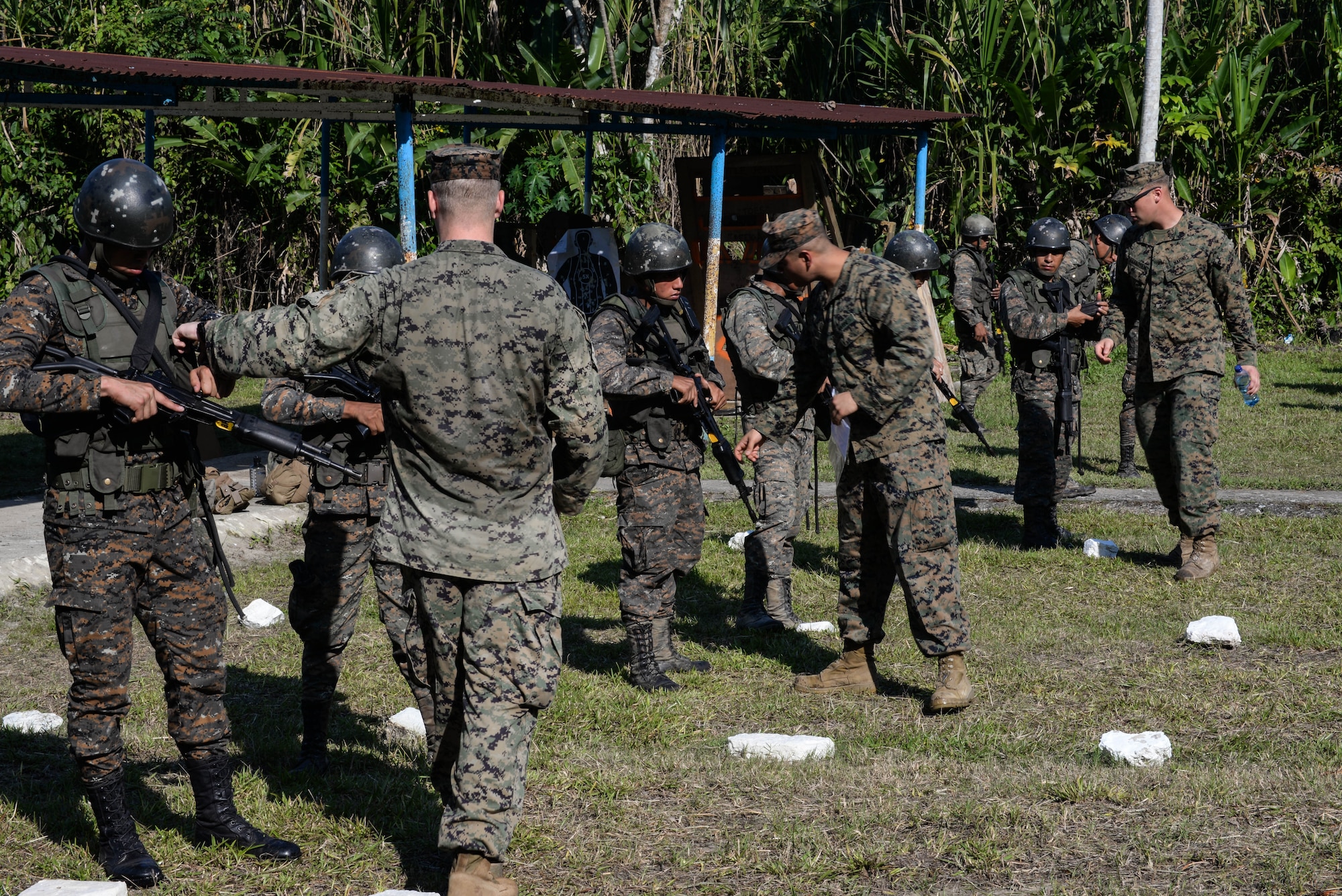 Trainers from a U.S. Marine Security Cooperation Team provide proper firing and safety techniques March 10, 2016, Guatemala, during a live-fire exercise. The exercise was part of a final evaluation in a four-week course requested by the Guatemalans, providing training and real-life simulations to help the Guatemalans conduct counter-drug operations. (U.S. Air Force photo by Staff Sgt. Westin Warburton/RELEASED)