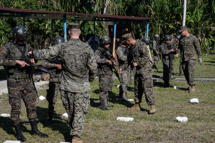 Trainers from a U.S. Marine Security Cooperation Team provide proper firing and safety techniques March 10, 2016, Guatemala, during a live-fire exercise. The exercise was part of a final evaluation in a four-week course requested by the Guatemalans, providing training and real-life simulations to help the Guatemalans conduct counter-drug operations. (U.S. Air Force photo by Staff Sgt. Westin Warburton/RELEASED)