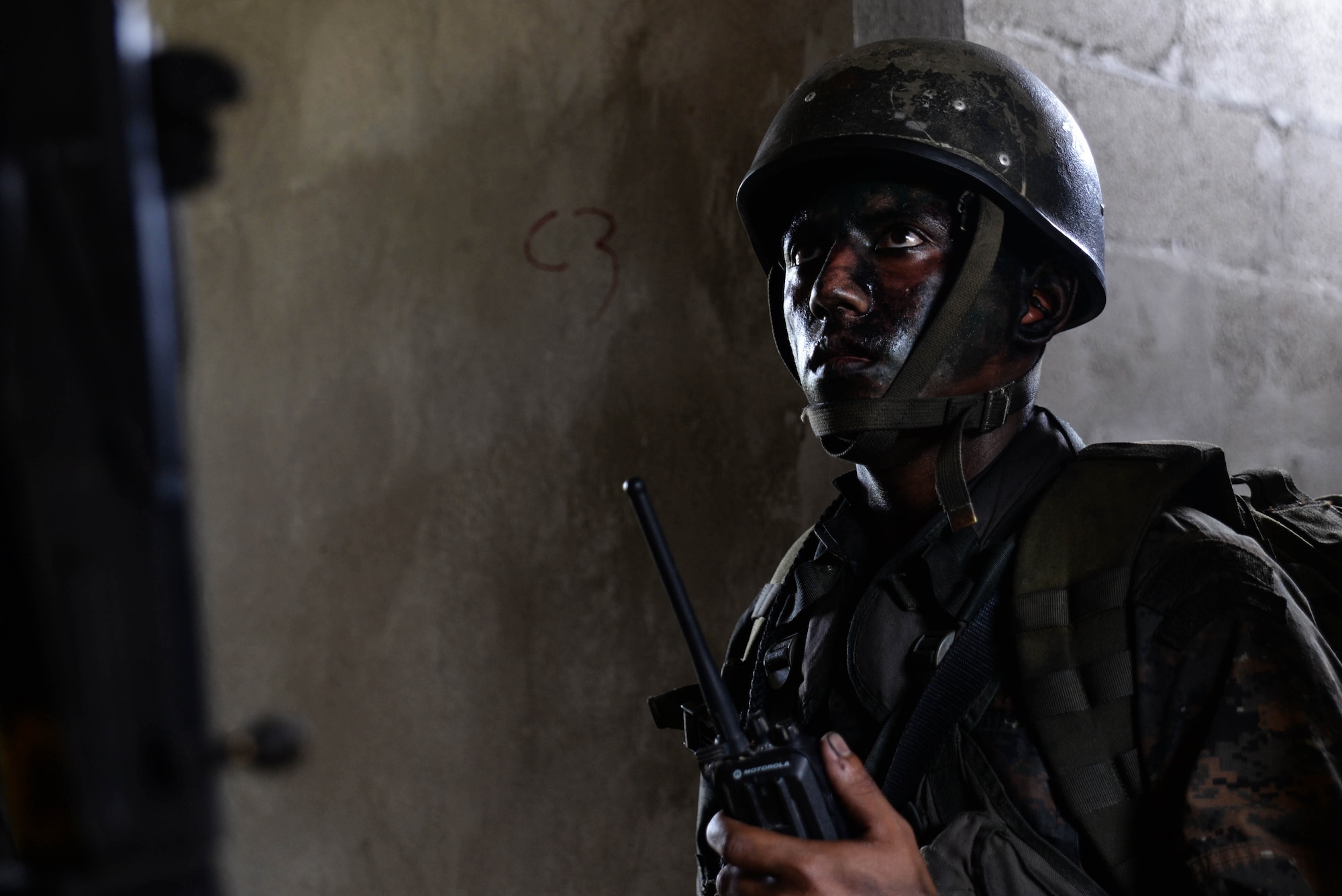 A Guatemalan Marine operates a radio March 9, 2016, Guatemala during a final squad-level training exercise. The Guatemalan marines participated in various exercises before graduating a four-week training course. Their U.S. Marine partners instructed to help evaluate best practices for small team movement and engagement. (U.S. Air Force photo by Staff Sgt. Westin Warburton/RELEASED)