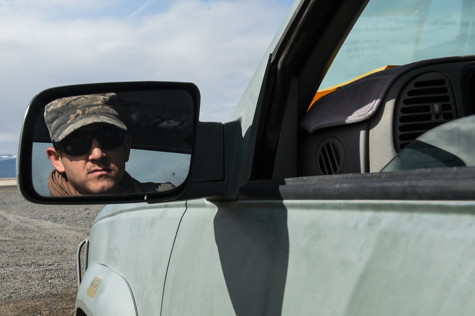 Senior Airman Christopher Traphagan, 821st Contingency Response Squadron Aerial Port Flight, looks through his rear view mirror while trying to back in a truck during Exercise Turbo Distribution 16-02, March 15, 2016, at Amedee Army Airfield, Calif. Turbo Distribution is used to evaluate mobility operations and expeditionary combat support. Unlike traditional, simulation based exercises, TD provides a dynamic venue with scenarios designed to challenge participants executing complex operations in a deployed environment. (U.S. Air Force photo by Staff Sgt. Robert Hicks/Released)