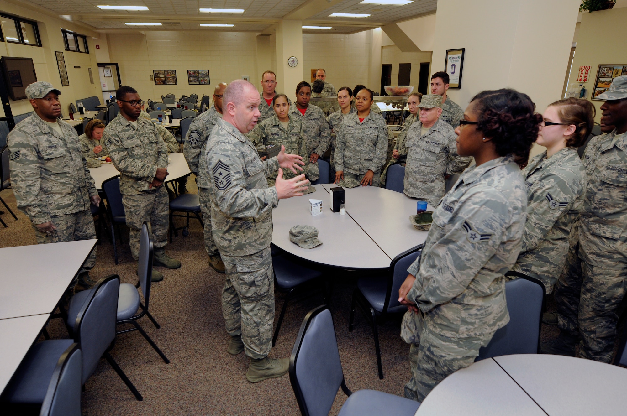 U.S. Air Force Command Chief Master Sergeant of the Air National Guard James W. Hotaling (center) gives a special thanks to members of the 145th Force Support Squadron working in the dining facility, for their hard work and contribution to the mission during his visit to the North Carolina Air National Guard Base, Charlotte Douglas International Airport, March 12, 2016. During the visit, Hotaling discussed his focus of renewing the commitment to the profession of arms, the health of the force, and recognizing the accomplishments of the 145th Airlift Wing. Hotaling also lead an all enlisted call to provide Airmen with an opportunity to ask questions about their concerns. (U.S. Air National Guard photo by Staff Sgt. Julianne M. Showalter/ Released)