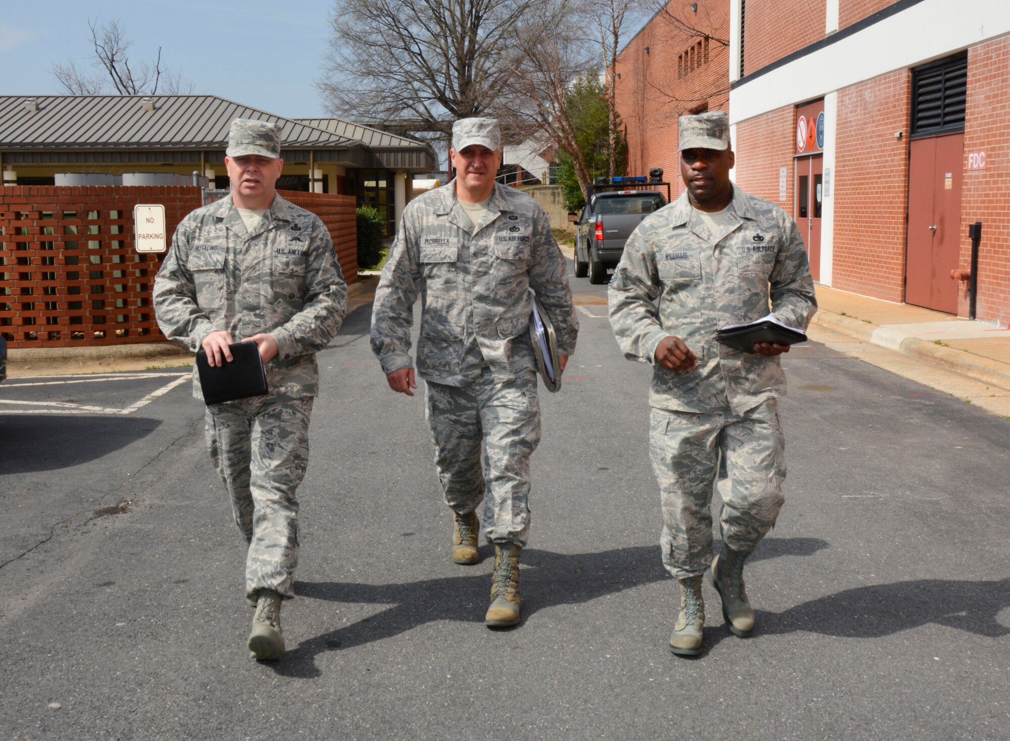 U.S. Air Force Chief Master Sgt. James W. Hotaling (left), command chief master sergeant of the Air National Guard, Chief Master Sgt. Salvatore Pecorella (center), command chief for the 145th Airlift Wing, and Chief Master Sgt. Maurice Williams (right), state command chief for the N.C. Air National Guard, walk about the N.C. Air National Guard Base, at Charlotte Douglas International Airport, March 12, 2016, following several motivating and inspirational leadership meetings with various Airmen.  (U.S. Air National Guard photo by Master Sgt. Rich Kerner/Released)