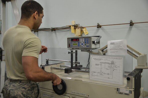 Staff Sgt. Micah Sheffield, 374th Maintenance Squadron Precision Measurement Equipment Laboratory physical dimensions NCO in charge, inspects a transducer to ensure it’s calibrated at Yokota Air Base, Japan, Feb. 22, 2016. The laboratory receives a variety of equipment to repair and inspect ranging from torque wrenches, spectrum analyzers, communication analyzers, avionics equipment and scales. (U.S. Air Force photo by Senior Airman David Owsianka/Released)