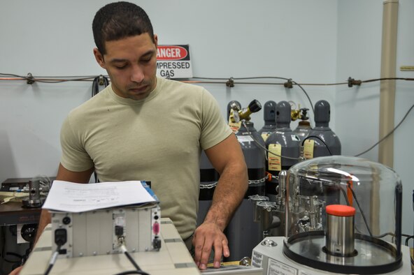 Staff Sgt. Micah Sheffield, 374th Maintenance Squadron Precision Measurement Equipment Laboratory physical dimensions NCO in charge, calibrates vacuum gage on a primary pressure standard at Yokota Air Base, Japan, Feb. 22, 2016. The PMEL flight ensures that every tool needed to make a quantitative measurement and to safely perform inspections and repairs on aircraft provide accurate data. (U.S. Air Force photo by Senior Airman David Owsianka/Released)