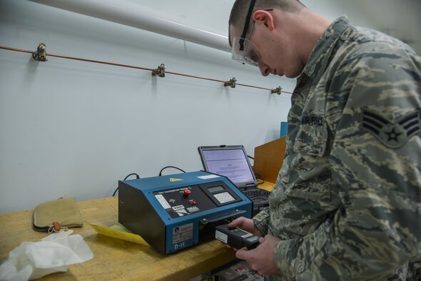 Senior Airman Michael Johnson, 374th Maintenance Squadron Precision Measurement Equipment Laboratory technician, uses a tachometer tester to assess a photo/contact tachometer at Yokota Air Base, Japan, Feb. 22, 2016. The PMEL flight ensures that every tool needed to make a quantitative measurement and to safely perform inspections and repairs on aircraft provide accurate data. (U.S. Air Force photo by Senior Airman David Owsianka/Released)