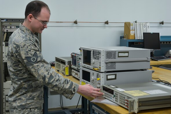 Staff Sgt. Sean Pentz, 374th Maintenance Squadron Precision Measurement Equipment Laboratory electronic supervisor, turns on a spectrum analyzer at Yokota Air Base, Japan, Feb. 22, 2016. Yokota’s PMEL flight provides calibration support for more than 4,000 pieces of equipment and 76 work centers, worth approximately $6.7 million. (U.S. Air Force photo by Senior Airman David Owsianka/Released)