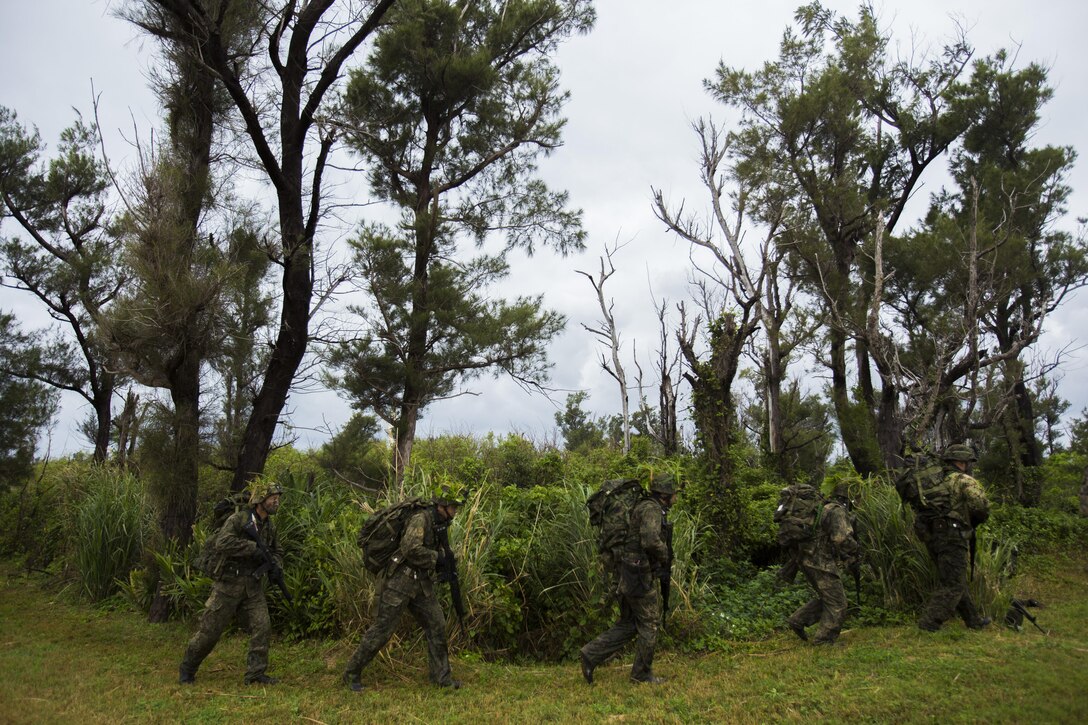 Japan Ground Self-Defense Force members move towards their objective Mar. 11, at Kin Blue, Okinawa, Japan. Their mission was to take over an enemy tent, without being detected, as they maneuvered through the jungle. The JGSDF members observed U.S. Marines with 3rd Reconnaissance Battalion, 3rd Marine Division, III Marine Expeditionary Force, conducting raid missions, amphibious training and scout swimmer classes. The JGSDF members are with the 43rd Infantry Regiment, 8th Division, Western Army.(U.S. Marine Corps photo by Cpl. Isaac Ibarra/Released)