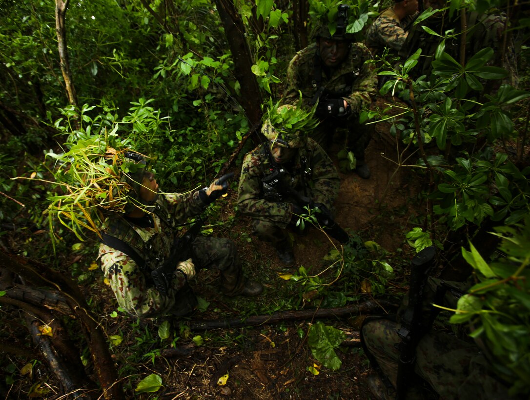 Japan Ground Self-Defense Force members plan the their team’s next maneuver Mar. 11, at Kin Blue, Okinawa, Japan. The JGSDF members observed U.S. Marines with 3rd Reconnaissance Battalion, 3rd Marine Division, III Marine Expeditionary Force, conducting raid missions, amphibious training and scout swimmer classes. The JGSDF members are with the 43rd Infantry Regiment, 8th Division, Western Army. (U.S. Marine Corps photo by Cpl. Isaac Ibarra/Released)