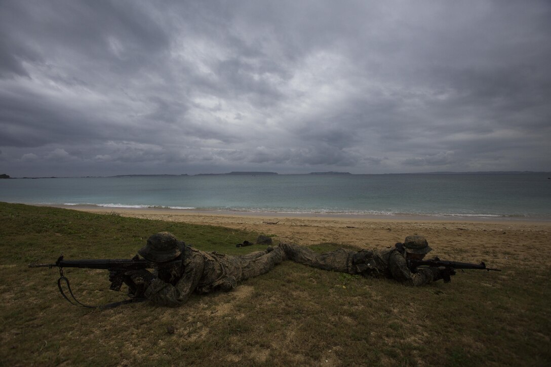 Japan Ground Self-Defense Force members set up security immediately after landing on the beach Mar. 11, at Kin Blue, Okinawa, Japan. The members arrived on rubber raid crafts after being called in by the first reconnaissance team. The JGSDF observed U.S. Marines with 3rd Reconnaissance Battalion, 3rd Marine Division, III Marine Expeditionary Force, conducting raid missions, amphibious training and scout swimmer classes. The JGSDF members are with the 43rd Infantry Regiment, 8th Division, Western Army. (U.S. Marine Corps photo by Cpl. Isaac Ibarra/Released)