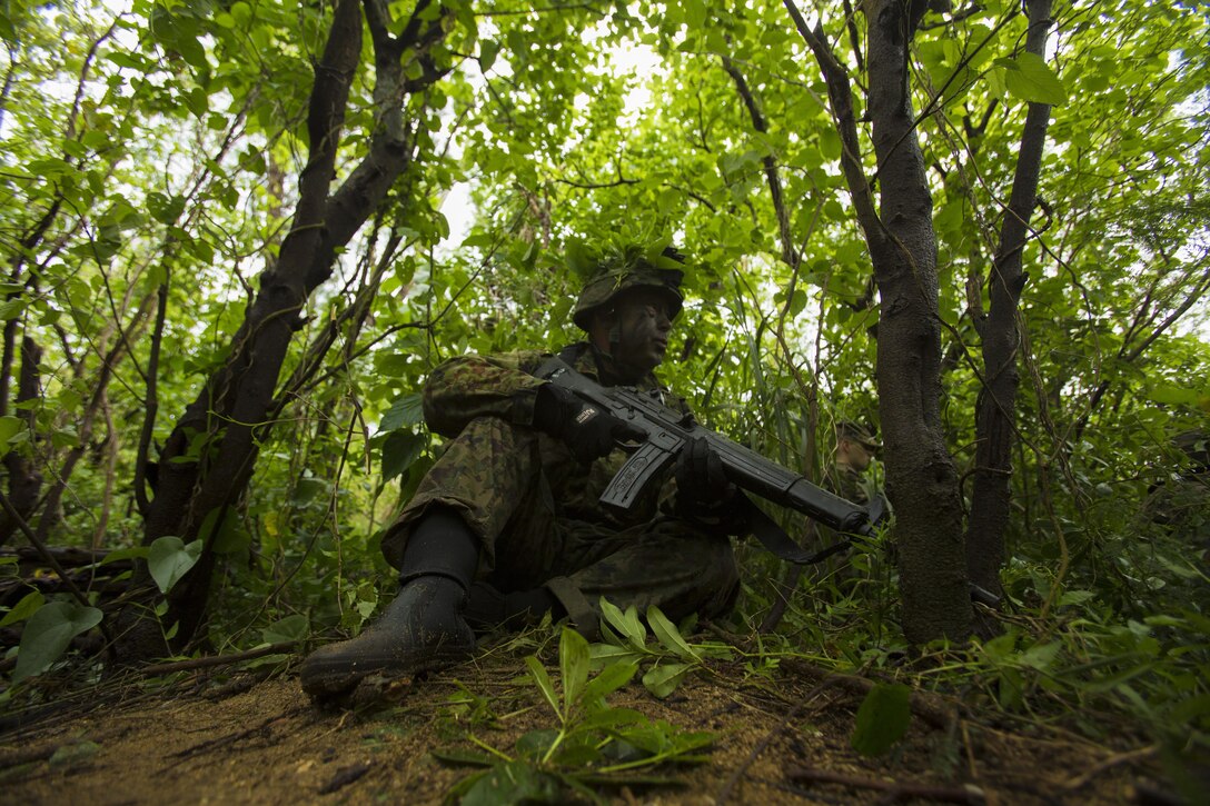 A Japan Ground Self-Defense Force member provides security for his team Mar. 11, at Kin Blue, Okinawa, Japan. The JGSDF observed U.S. Marines with 3rd Reconnaissance Battalion, 3rd Marine Division, III Marine Expeditionary Force, conducting raid missions, amphibious training and scout swimmer classes. The JGSDF members are with the 43rd Infantry Regiment, 8th Division, Western Army. (U.S. Marine Corps photo by Cpl. Isaac Ibarra/Released)