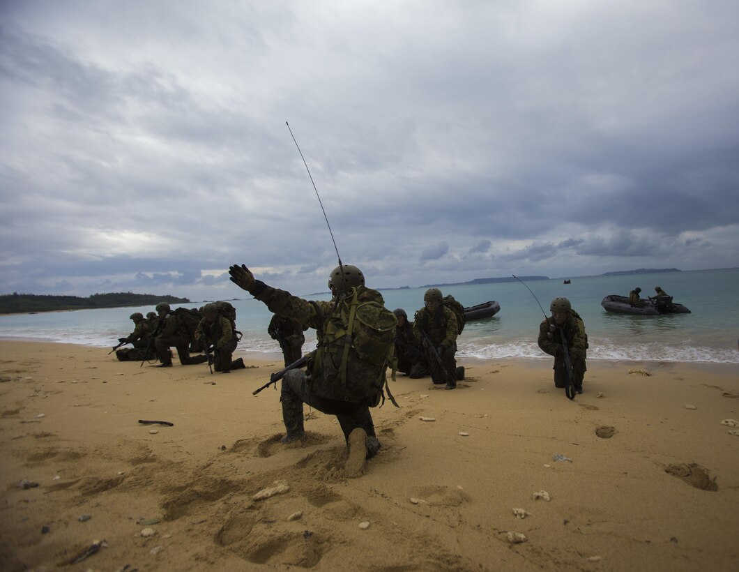 Japan Ground Self-Defense Force members land on the beach Mar. 11, at Kin Blue, Okinawa, Japan. The JGSDF members observed U.S. Marines with 3rd Reconnaissance Battalion, 3rd Marine Division, III Marine Expeditionary Force, conducting raid missions, amphibious training and scout swimmer classes. The JGSDF members are with the 43rd Infantry Regiment, 8th Division, Western Army. (U.S. Marine Corps photo by Cpl. Isaac Ibarra/Released)