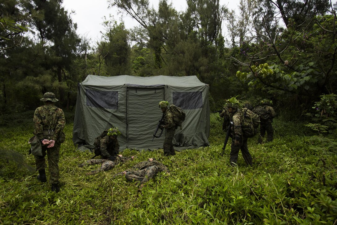 Japan Ground Self-Defense Force members take over their objective Mar. 11, at Kin Blue, Okinawa, Japan. The JGSDF members observed U.S. Marines with 3rd Reconnaissance Battalion, 3rd Marine Division, III Marine Expeditionary Force, conducting raid missions, amphibious training and scout swimmer classes. The JGSDF members are with the 43rd Infantry Regiment, 8th Division, Western Army. (U.S. Marine Corps photo by Cpl. Isaac Ibarra/Released)