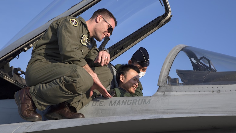 Capt. Robert Ahern, a F/A-18 pilot with Marine Fighter Attack Squadron 314, shows an F/A-18 aircraft to Japan Air Self-Defense Force members during the Komatsu Aviation Training Relocation exercise at Komatsu Air Base, Japan, March 17, 2016. VMFA-314, home based out of Marine Corps Air Station Miramar, San Diego, temporarily deployed to MCAS Iwakuni for a six month rotation with the unit deployment program, is forward deployed to Komatsu, Japan for the ATR. 
