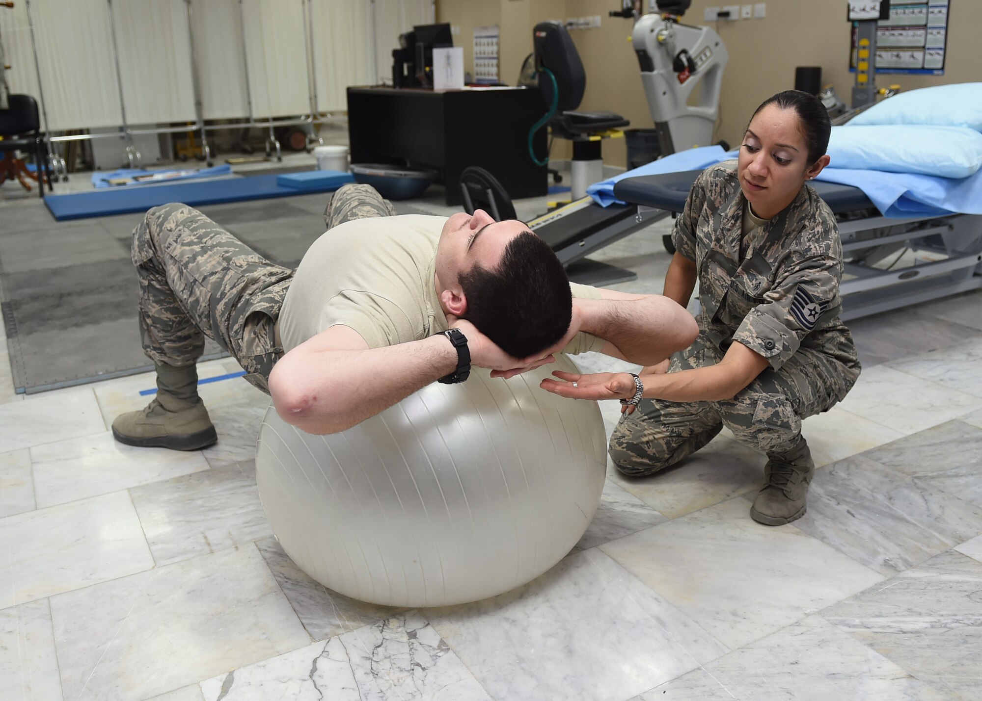 Tech. Sgt. Ruth Garcia, 386th Expeditionary Medical Group physical therapy technician, instructing a patient of proper exercise technique at an undisclosed location in Southwest Asia, March 11, 2016.The physical therapy clinic offers a variety of services including musculoskeletal evaluation and treatment, rehabilitative exercise, stretching, neuromuscular education, postural awareness, and modalities for pain management. (U.S. Air Force photo by Staff Sgt. Jerilyn Quintanilla) 