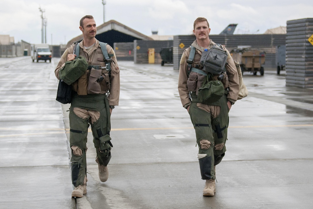 Air Force Capts. Brad Hunt, right, and Tim Six walk to their F-16 Fighting Falcon aircraft on Bagram Airfield, Afghanistan, March 14, 2016, before a combat sortie. Air Force photo by Tech. Sgt. Robert Cloys