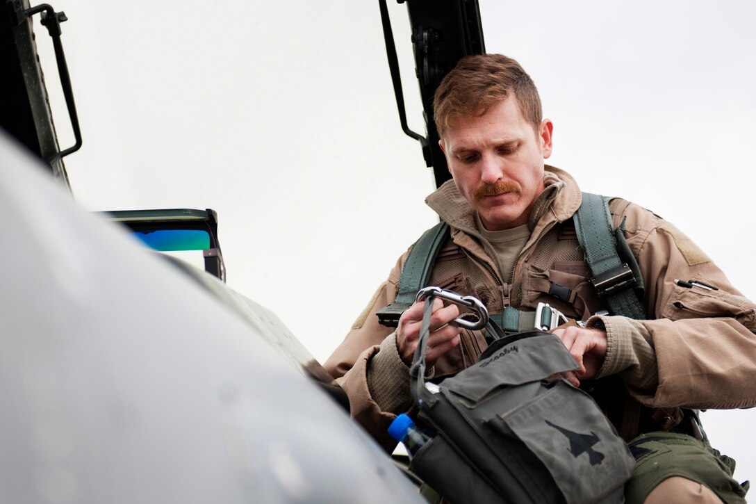 Air Force Capt. Brad Hunt prepares his gear on Bagram Airfield, Afghanistan, March 14, 2016, before a combat sortie. Air Force photo by Tech. Sgt. Robert Cloys