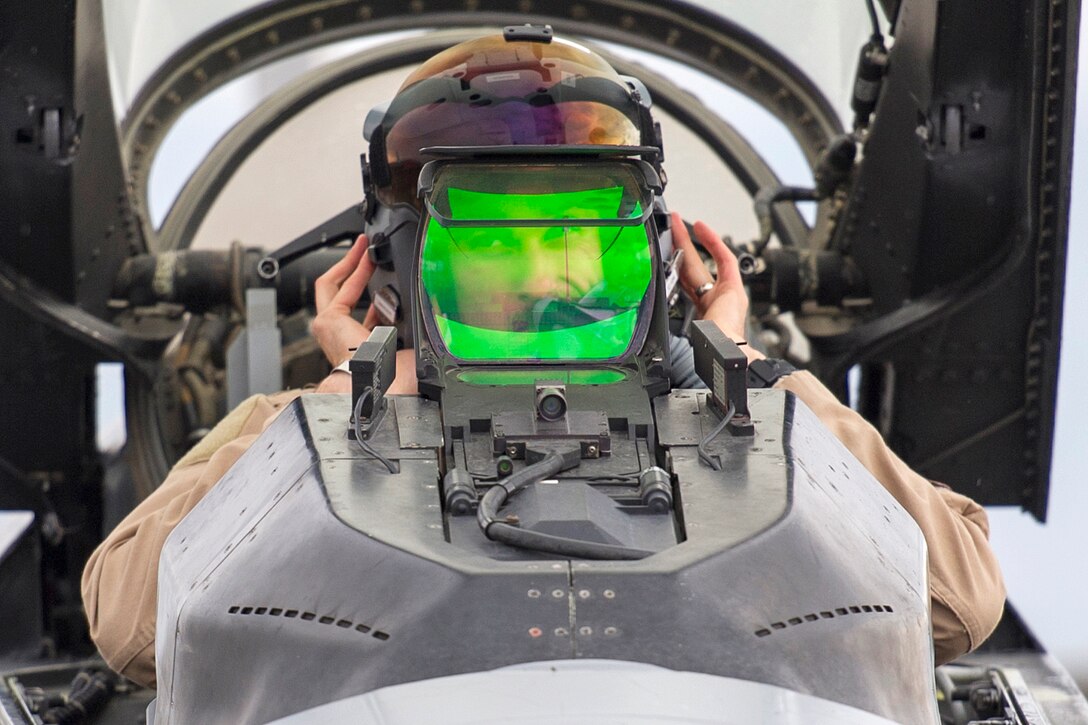 Air Force Capt. Tim Six performs preflight checks on an F-16 Fighting Falcon aircraft on Bagram Airfield, Afghanistan, March 14, 2016, before a combat sortie. Air Force photo by Tech. Sgt. Robert Cloys