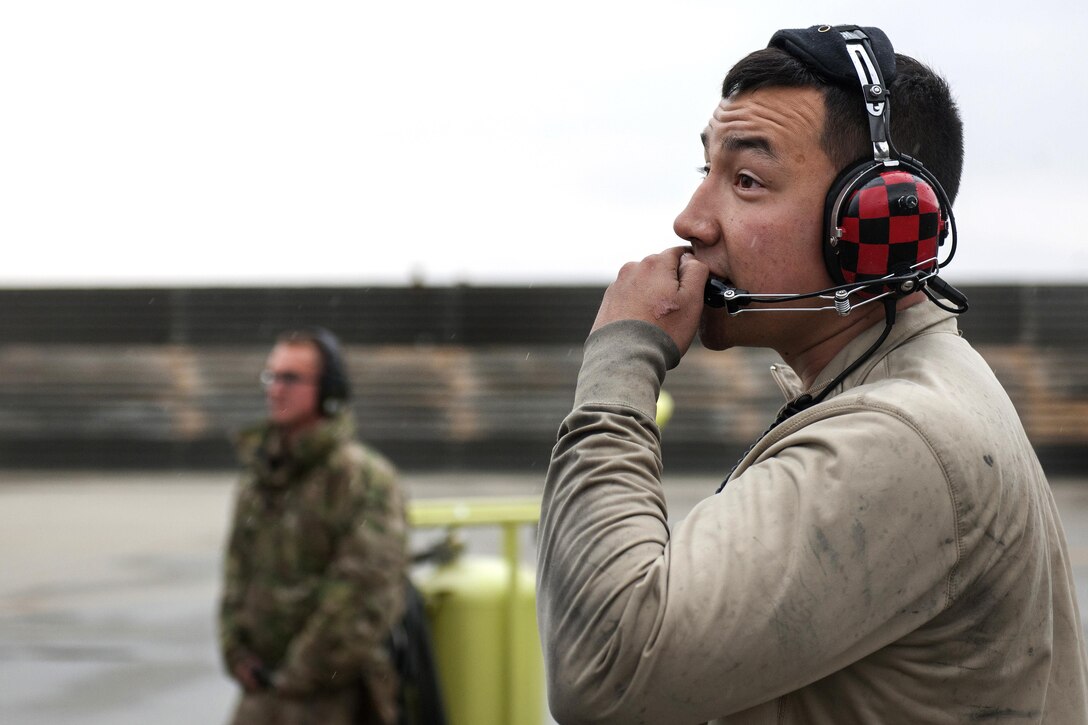 Air Force Staff Sgt. Steven Benton, foreground, performs preflight checks on an F-16 Fighting Falcon aircraft on Bagram Airfield, Afghanistan, March 14, 2016, before a combat sortie. Benton is a crew chief assigned to the 455th Expeditionary Aircraft Maintenance Squadron. Air Force photo by Tech. Sgt. Robert Cloys