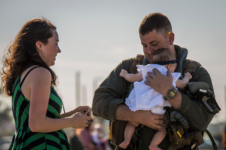 A pilot greets his family on the flightline aboard Marine Corps Air Station Beaufort March 15. More than 180 Marines and 10 F/A-18D Hornet aircraft have been deployed to the Western Pacific since October 2015 as part of the Unit Deployment Program. The pilot is with VMFA(AW)-224. 