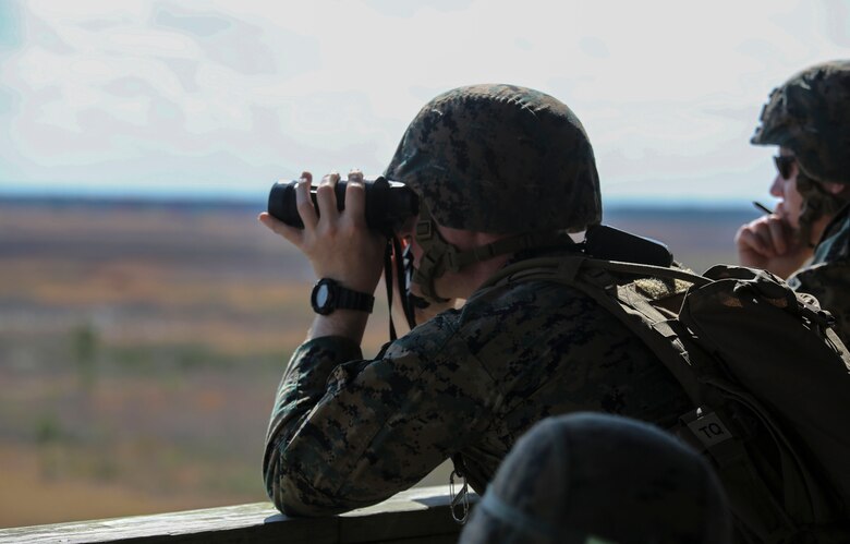 Capt. Justin L. Carter, a forward air controller with 2nd Battalion, 8th Marine Regiment, observes targets down range during a fire support coordination exercise at Camp Lejeune, N.C., March 15, 2016. The exercise was the first to allow the unit to collaborate with their 1st Battalion, 10th Marine Regiment attachment that will be among them during their upcoming deployment. (U.S. Marine Corps photo by Cpl. Paul S. Martinez/Released)